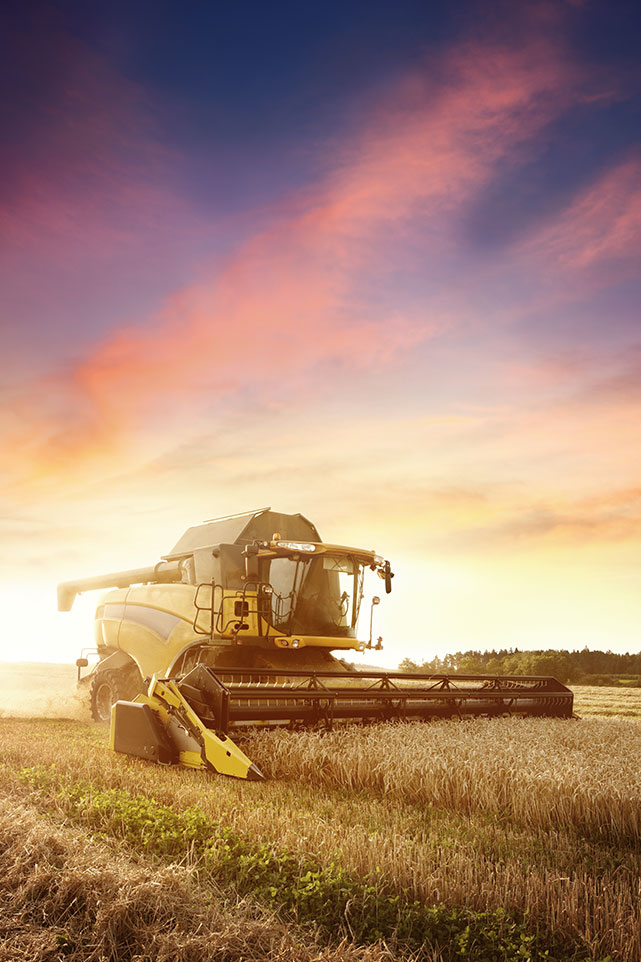 Swather in filed at harvest time